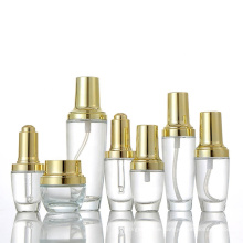 Customized cosmetic packaging clear luxury glass cosmetic bottles and cream jars with gold lid